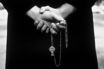 Priest holding a rosary