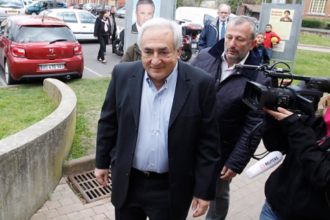 Former IMF head Strauss-Kahn leaves after he voted in the first round of the 2012 French presidential election at a polling station in Sarcelles