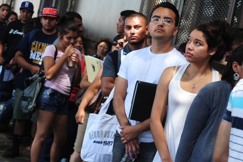 Young people wait in line to enter the o