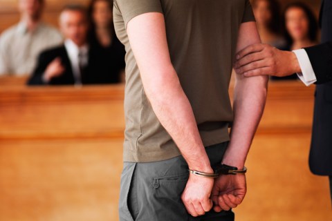Image: Handcuffed man standing in courtroom