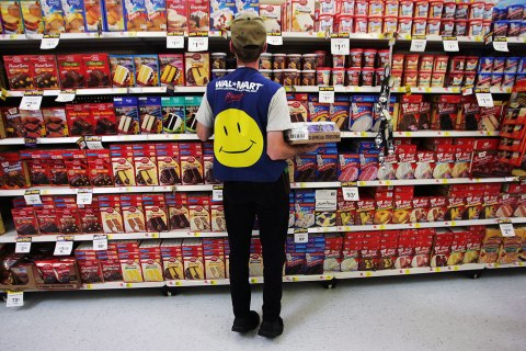 Wal-Mart Dominates U.S. Retail Economyimage: An employee restocks a shelf in the grocery section of a Wal-Mart Supercenter in Troy, Ohio, May 11, 2005. 