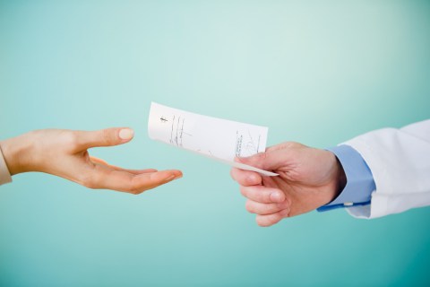 Image: Doctor handing a prescription to a patient