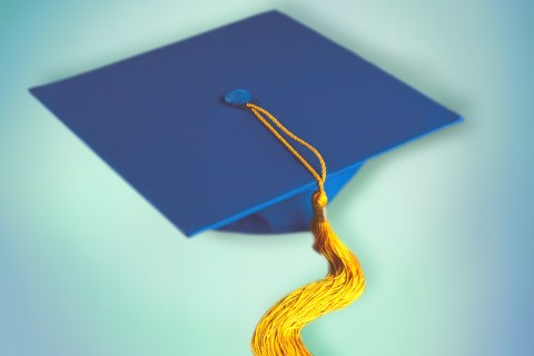 A graduation cap with tassles dangling