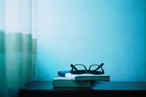 Book and glasses on table