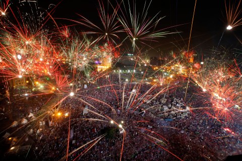 Fireworks light the sky as opponents of Egypt's Islamist President Mohammed Morsi celebrate in Tahrir Square in Cairo, Egypt, Wednesday, July 3, 2013.