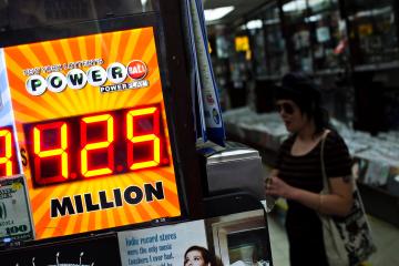 A woman buys a Powerball lottery ticket at a convenience store in New York City, on Aug. 7, 2013.