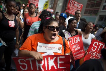 Demonstrators in support of fast food workers march towards a McDonald's as they demand higher wages and the right to form a union without retaliation in New York City, on July 29, 2013.