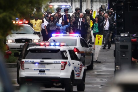 People are evacuated from a building after the shooting at the Washington Navy Yard in Washington, D.C., on Sept. 16, 2013
