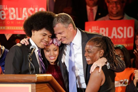 New York City Democratic mayoral hopeful Bill de Blasio embraces his son Dante, left, daughter Chiara, second from left, and wife Chirlane McCray, right, at his election headquarters after polls closed in the city's primary election Tuesday, Sept. 10, 2013, in New York.