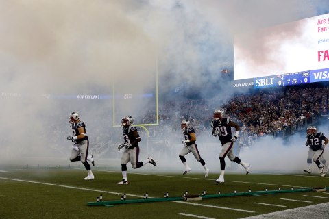 The New England Patriots run onto the field before an NFL football game against the New York Jets Thursday, Sept. 12, 2013, in Foxborough, Mass. 