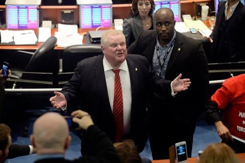 Toronto Mayor Rob Ford reacts after walking around council chambers while an unidentified member of his staff captured images of the public gallery during a special council meeting at City Hall in Toronto