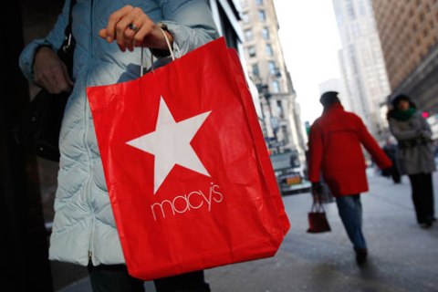 A woman holds a Macy's Inc shopping bag outside a store in New York City, on  Jan. 7, 2010.