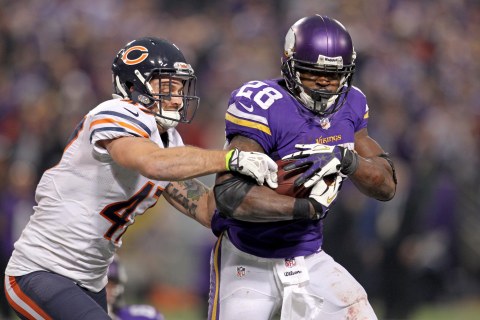 From right: Minnesota Vikings running back Adrian Peterson (28) is tackled by Chicago Bears safety Chris Conte (47) during overtime at Mall of America Field at H.H.H. Metrodome, in Minneapolis on Dec. 1, 2013.
