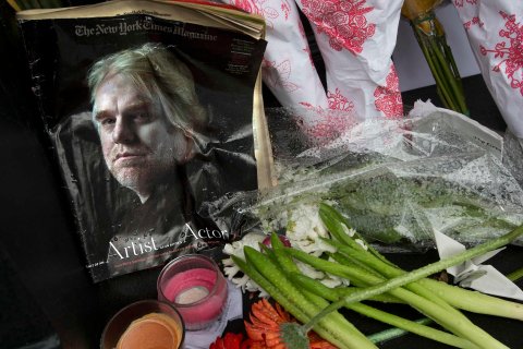 A copy of a New York Times Magazine with a photo of movie actor Philip Seymour Hoffman on the cover in a memorial in front of his apartment building in New York City, on Feb. 3, 2014.