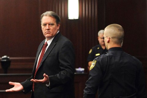 Michael Dunn raises his hands in disbelief as he looks toward his parents after the verdicts were announced in his trial in Jacksonville