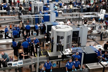 Transportation Security Agency (TSA) workers carry out security checks at Denver International Airport.